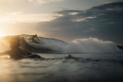 Cutting shiny green walls of water, surfphotography at golden hour