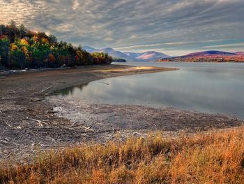 Scenic view of lake against sky during sunset