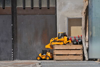 Yellow construction site on road against wall