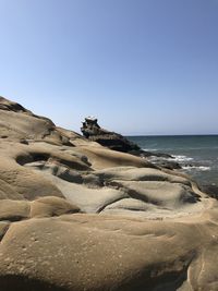 Scenic view of beach against clear sky