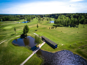 Scenic view of golf course against sky