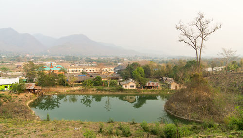 Scenic view of river by houses against clear sky