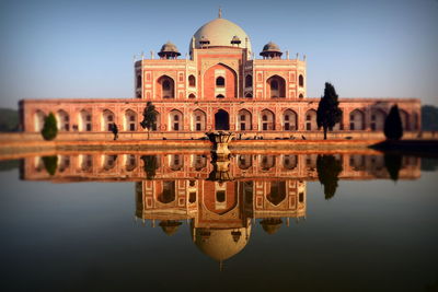 Reflection of temple against clear sky