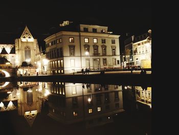 Reflection of illuminated buildings in water at night