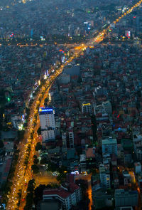 High angle view of city lit up at night