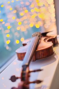 Close-up of violin on window sill at night