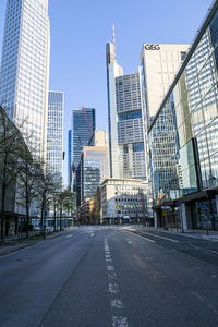 Road amidst buildings against sky in city