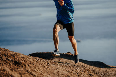 Low section of man running on mountain