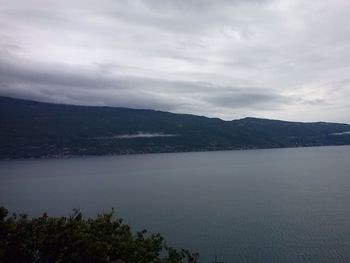 Scenic view of calm sea against cloudy sky