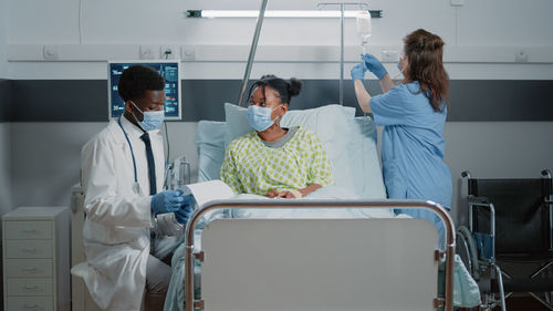 Female doctor examining patient in hospital