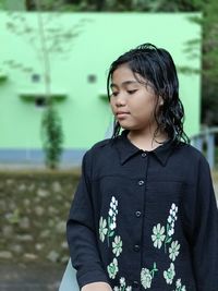 Portrait of young woman standing outdoors