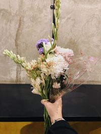 Cropped hand of bride holding bouquet