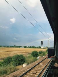 Train on railroad track against sky