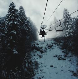 Ski lift over snow covered mountains