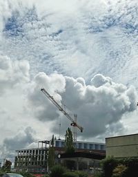 Low angle view of crane against sky