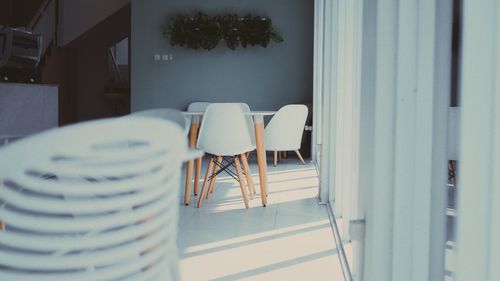 Empty chairs and tables in room