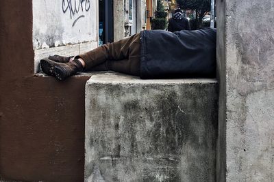 Low section of man sleeping on floor