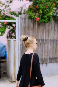 Mid adult woman walking on street in city