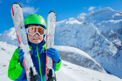 Low angle view of woman skiing on snowcapped mountain