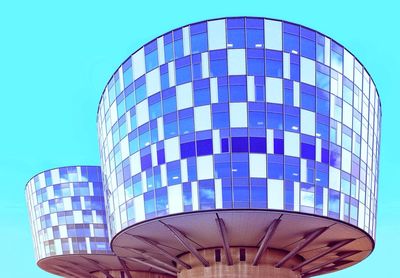 Low angle view of modern building against clear blue sky