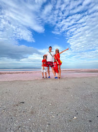 Family on a pink salt lake in the island of coche in the caribbean in venezuela