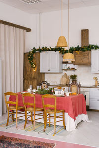 Vintage dining room, decorated for christmas and new year. large dining table with pink tablecloth