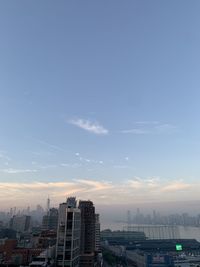 Buildings in city against sky during sunset