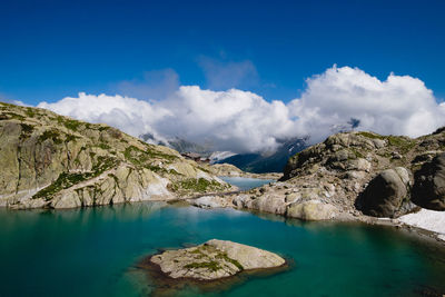 Panoramic view of lake and mountains against blue sky