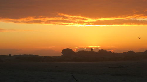 Scenic view of sea against orange sky