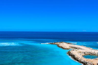 Scenic view of sea against clear blue sky