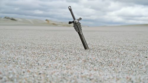 Close-up of sand on beach against sky