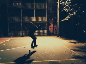 Man walking on street at night