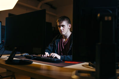 Businesswoman using laptop at desk in office