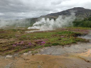 Scenic view of landscape against cloudy sky