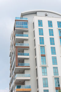 Modern tall residential apartment building with french windows. vertical shot.