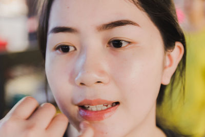 Close-up of young woman looking away