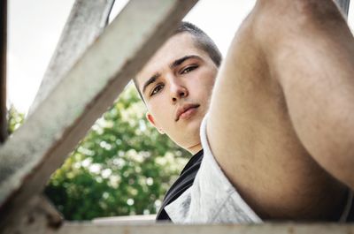 Portrait of young man looking away outdoors