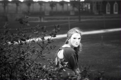 Girl wearing mask on field