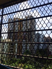 Close-up of chainlink fence against sky