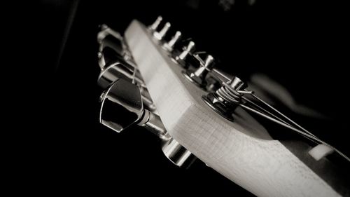 Close-up of guitar against black background