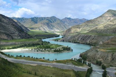 The blue katun river flows in a high-mountain gorge in altai and merges with the chuya river, summer