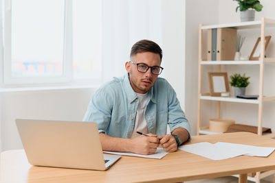 Young man using laptop at home