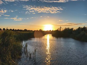 Scenic view of lake against sky during sunset