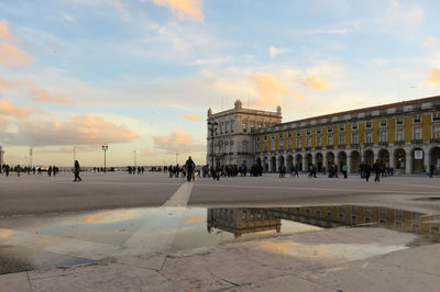 People at town square against sky during sunset