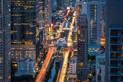 Aerial view of illuminated buildings in city at night