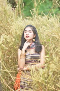 Portrait of beautiful young woman in field
