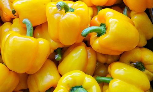 Full frame shot of yellow bell peppers for sale in market