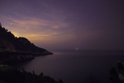 Scenic view of sea against sky at night