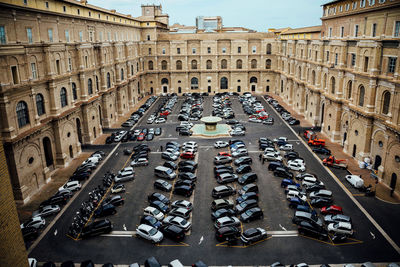 High angle view of cars parked on road amidst buildings