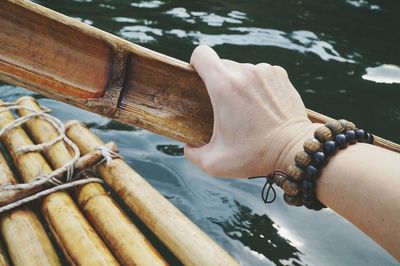 Close-up of rope tied to boat sailing in sea